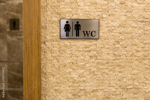 Fototapeta Naklejka Na Ścianę i Meble -  Toilet sign. Textured marble wall. The symbol of the male and female toilet.