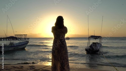 Woman taking picture in Mexico at Sunrise