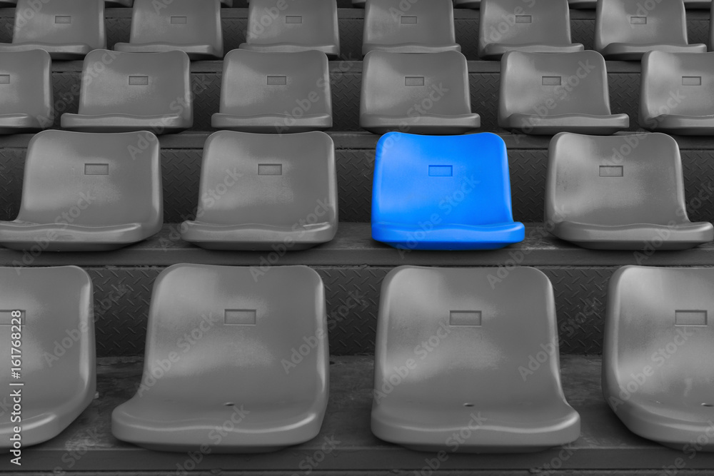 stadium seats with one highlighted on blue stadium seats with one highlighted on blue