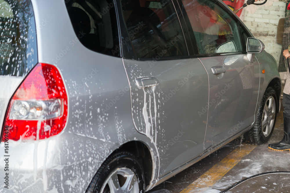 washing a car with soapy water