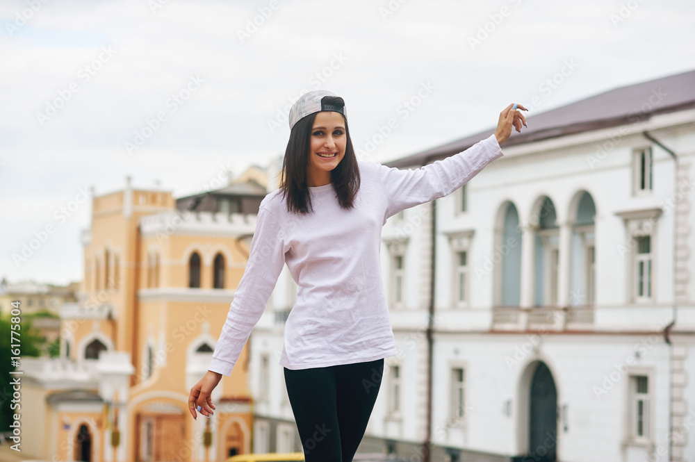 Cheerful young beautiful stylish girl in town .The concept of Hiking