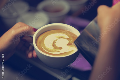 how to make latte art by barista focus in milk and coffee in vintage color