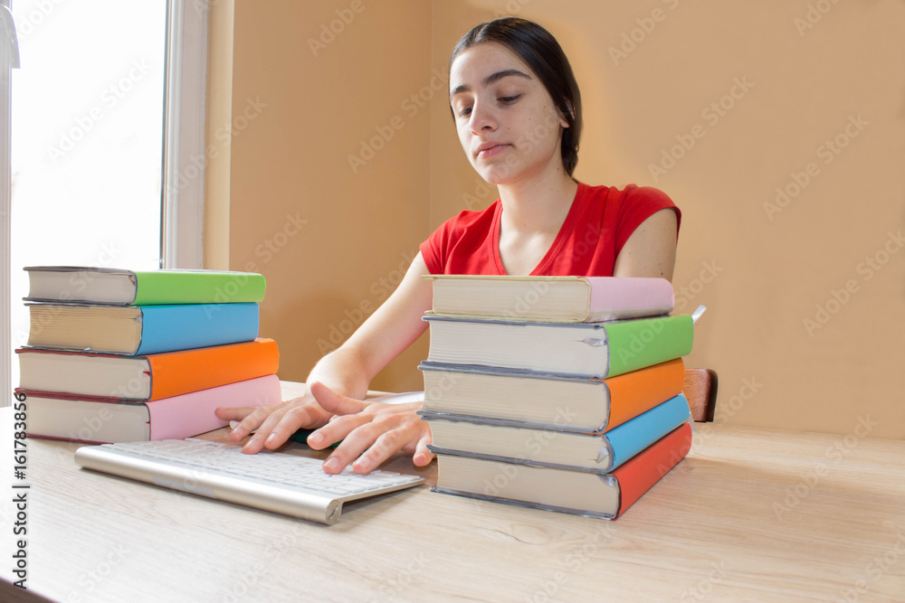 Girl doing her homework. School books on desk, education concept. Young Girl doing lessons at home Girl doing her homework. School books on desk, education concept. Young Girl doing lessons at home