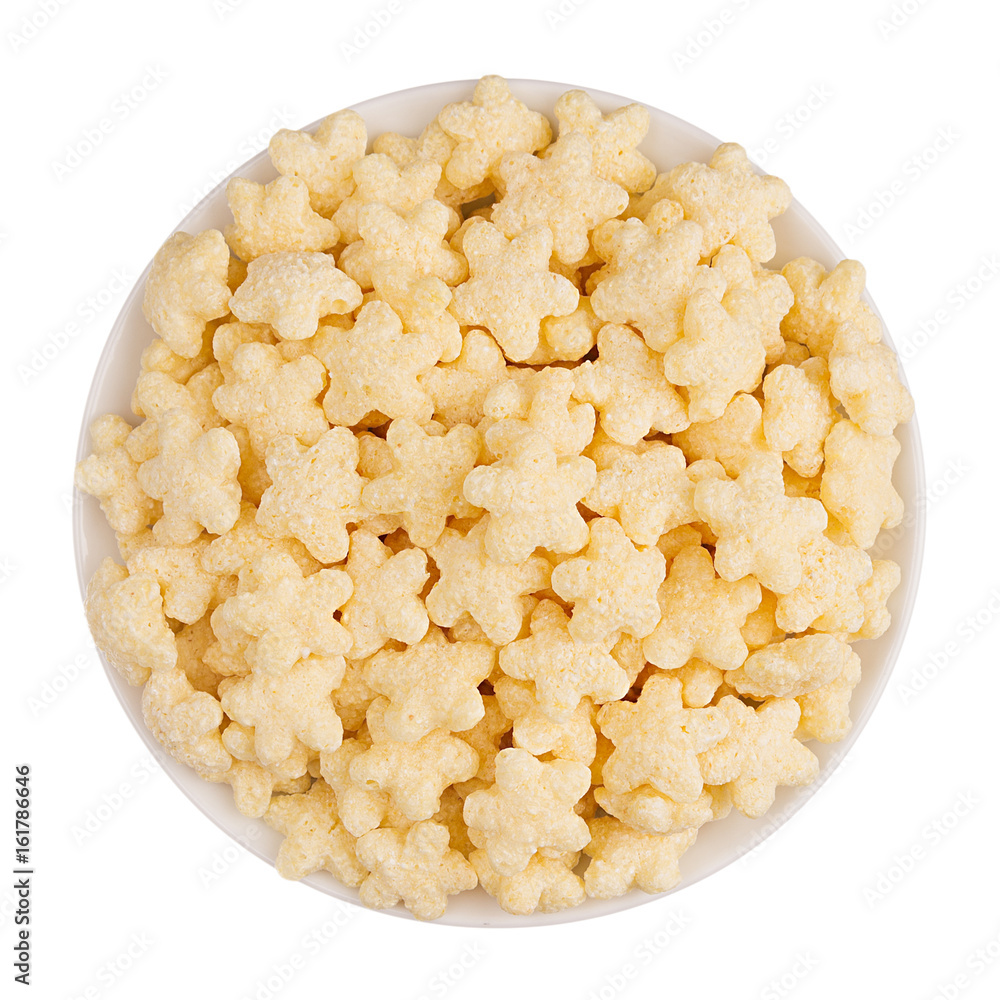 Yellow star corn flakes in white bowl isolated, top view. Yellow star corn flakes in white bowl isolated, top view.