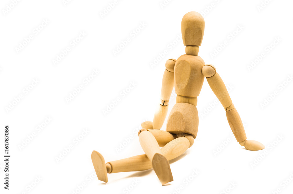 wooden man puppet sitting on white background in a relaxed pose wooden man puppet sitting on white background in a relaxed pose