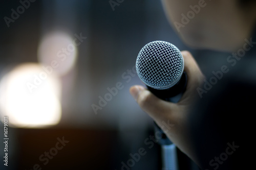 Fotografie, Obraz Blurred of businessman or speaker hand holding microphone for speech presentatio