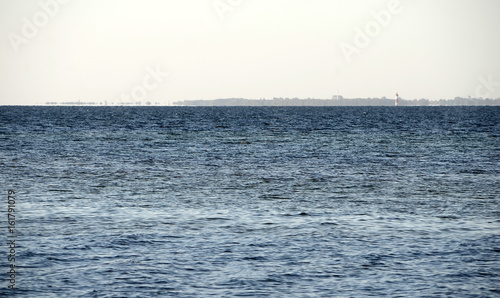 mirage over the sea, the land in the background with no less that 3 lighthouses seems to hover on the water surface. photo