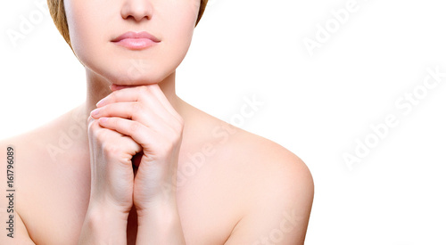 Portrait of girl with nude make-up with hands on chin isolated on white background, free space for text. Girl with clean healthy skin on white, copy space. Beauty model isolated on white
