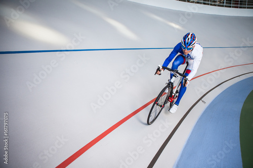 Racing cyclist on velodrome outdoor. photo