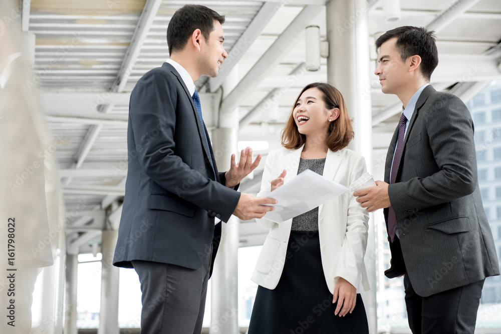 Business people talking at outdoor covered walkway Business people talking at outdoor covered walkway