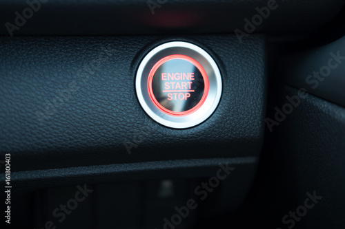 start button engine with light and have black leather console car interior detail. 