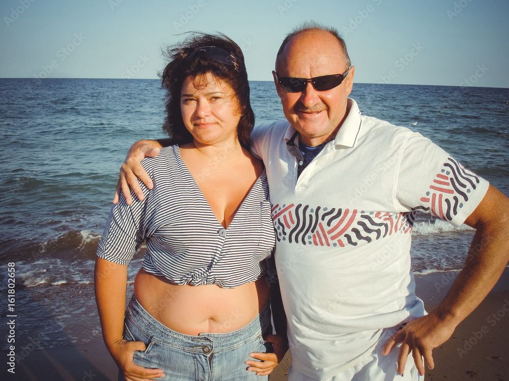 © T.Den_Team - A married couple of middle-aged, ordinary Americans with a little excess weight, rest by the sea, spend the weekend © T.Den_Team - A married couple of middle-aged, ordinary Americans with a little excess weight, rest by the sea, spend the weekend