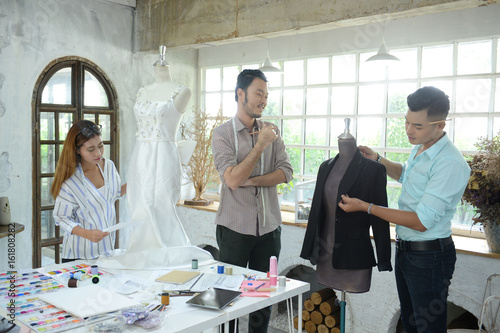 designer concept : Fashion designer working near mannequin in office