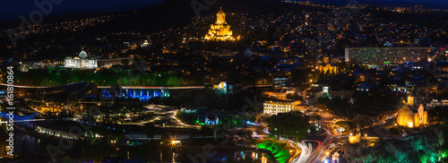 Night panorama view of Tbilisi, capital of Georgia country. Metekhi church, Holy Trinity Cathedral (Sameba) and Presidential Administration at night with illumination and moving cars. © Konstantin Aksenov