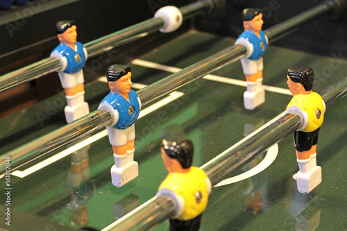Foosball, Table football game or Table Soccer with yellow and blue players