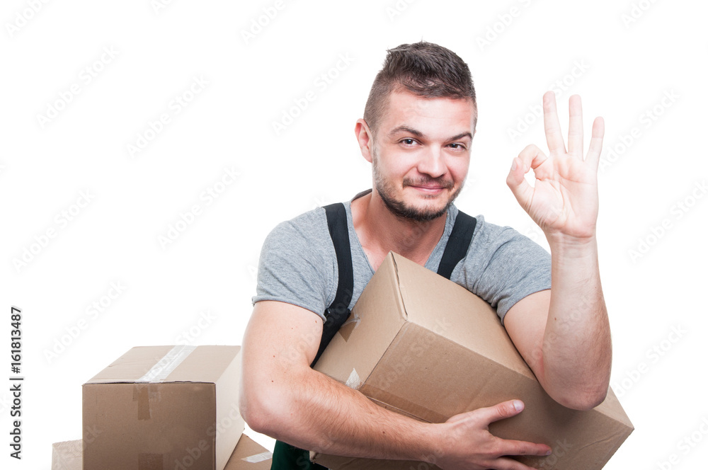 Mover guy holding cardboard box showing okay gesture Mover guy holding cardboard box showing okay gesture