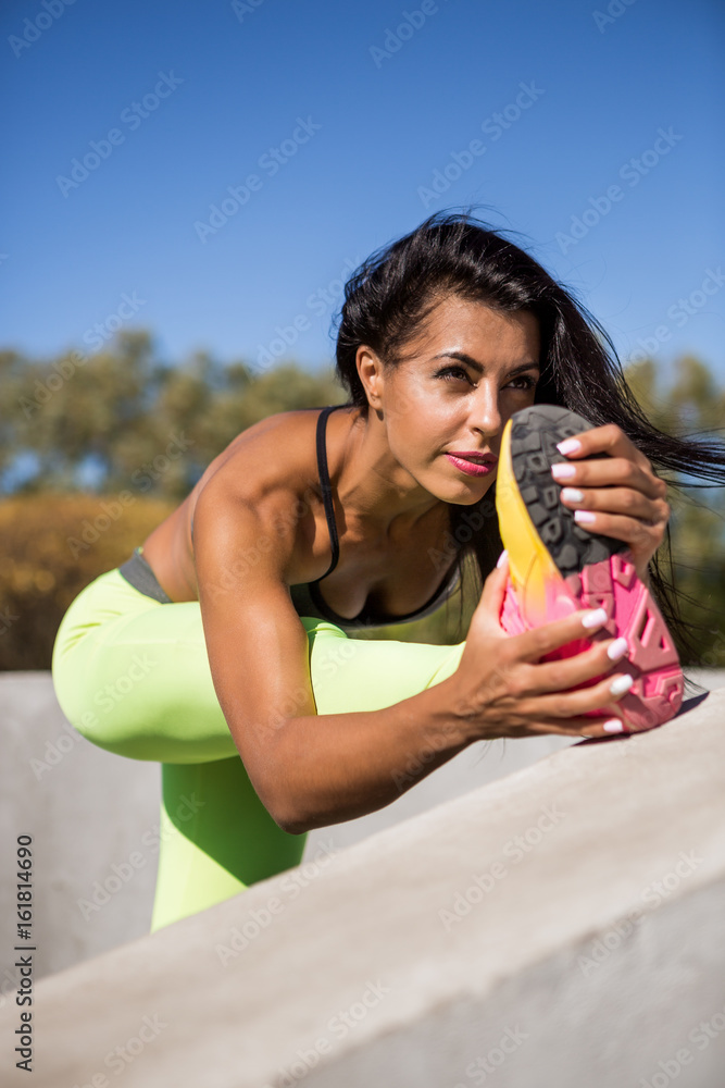 Beautiful Young Woman With Long Legs In Bright Sexy Leggings With Pretty  Athlete Muscular Body Stretching Before Yoga. Crossfit Training Urban Area  Street Gym City Exercise Routine Healthy Lifestyle. Stock Photo, Picture