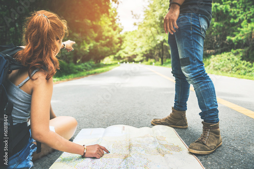 Lover women and men travel. Female travelers travel nature view map on the road