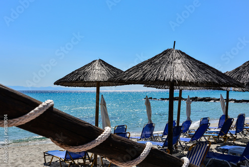 Sunbeds and umbrellas on the beach against a bright turquoise sea