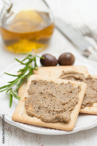 pate with toasts on white plate