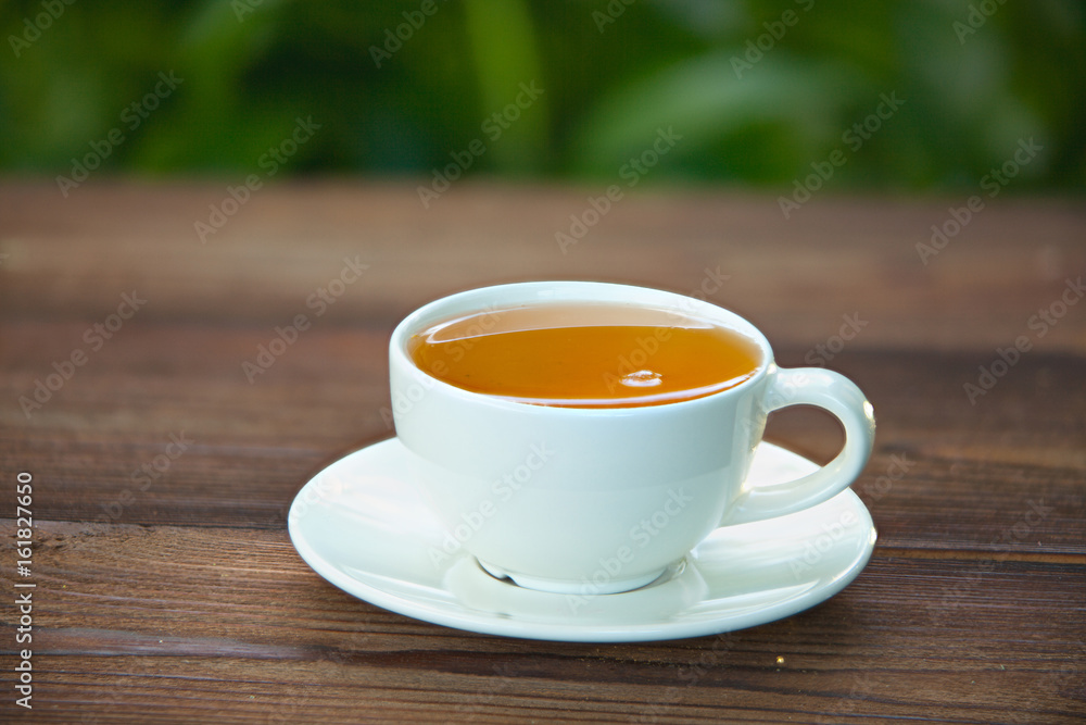 porcelainl cup with green tea on table porcelainl cup with green tea on table
