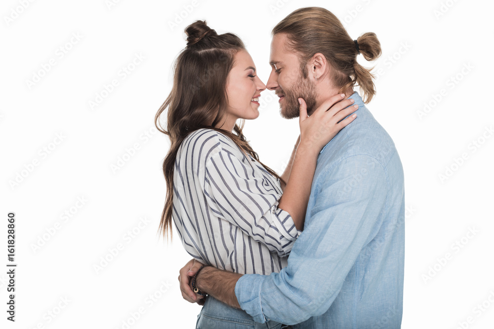 Side view of happy young couple able to kiss isolated on white Side view of happy young couple able to kiss isolated on white