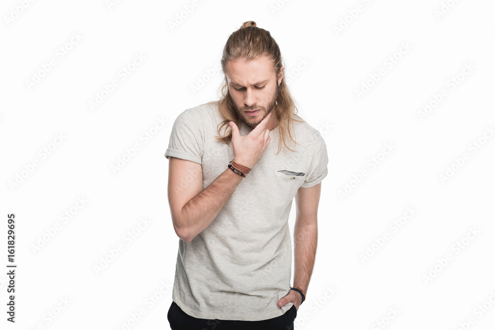 young pensive man gesturing and looking down, isolated on white young pensive man gesturing and looking down, isolated on white