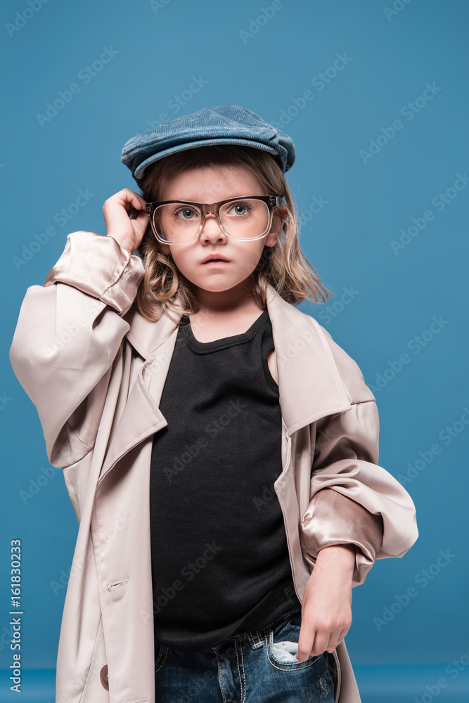 portrait of caucasian child girl in glasses and oversized coat looking away portrait of caucasian child girl in glasses and oversized coat looking away