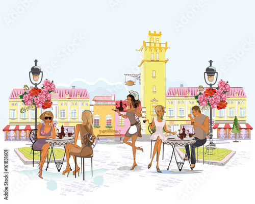 Fashion girls in the street cafe. Street cafe with flowers in the old city. Waiters serve the tables.