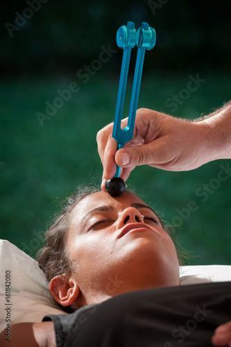 Slika na platnu The chakra stimulation with the tuning fork