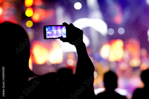 People at concert shooting video