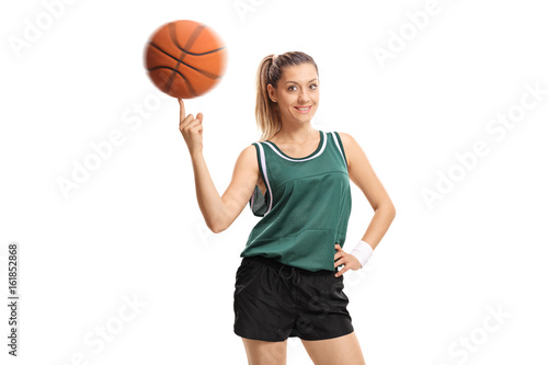 Young woman spinning a basketball on her finger