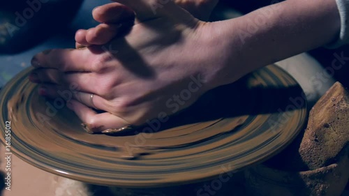 Close up of hands shaping clay pot