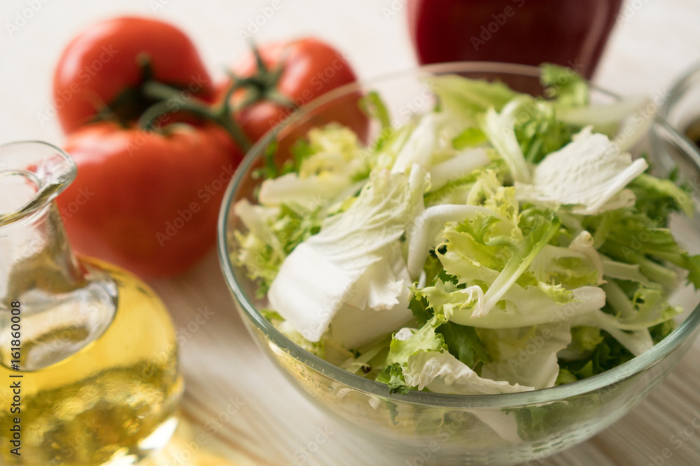 Salad ingridients. Tomato, lettuce, paprika and olive oil. Salad ingridients. Tomato, lettuce, paprika and olive oil.