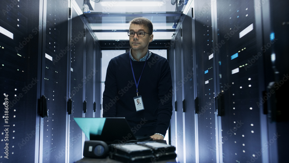 Shot of Server Engineer Pushing Crash Cart with Laptop, Hard Drives and ...