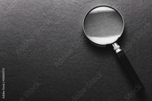 magnifying glass on  black texture  background.