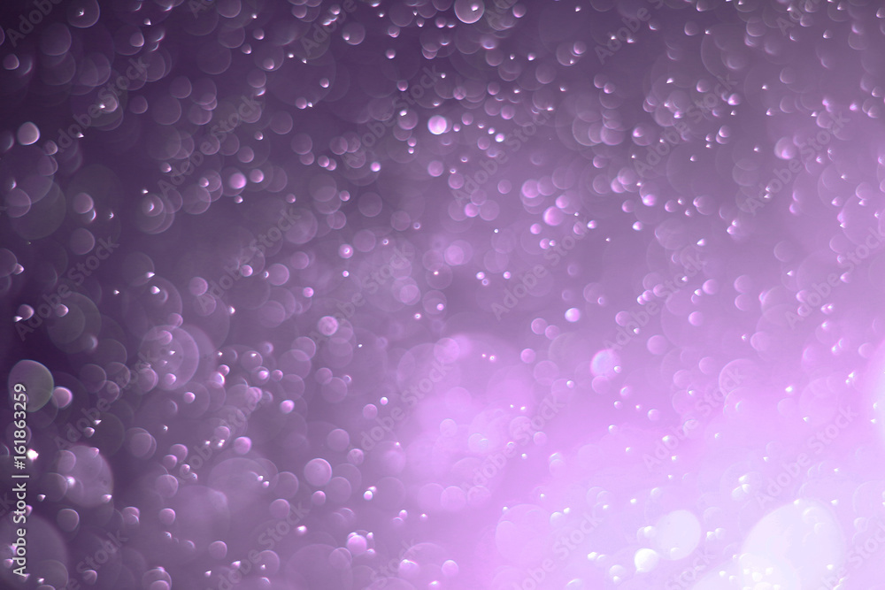 A beautiful and blurry bokeh on a purple background. A beautiful and blurry bokeh on a purple background.
