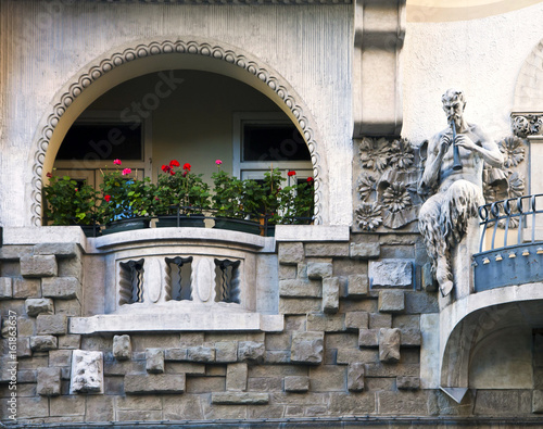 Foto Art nouveau building facade with faun playing flute