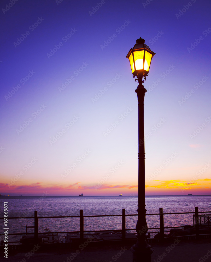 Street lamp and sunset on sea Street lamp and sunset on sea