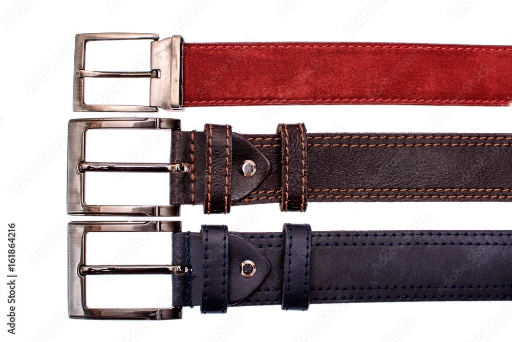 Several fashionable male belts red gray brown isolated on white background Several fashionable male belts red gray brown isolated on white background