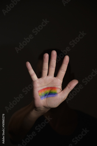 man with a rainbow flag in his hand