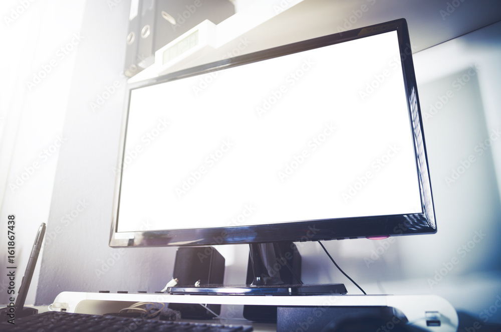 Fototapeta premium Desktop computer on desk in home office interior, blank screen