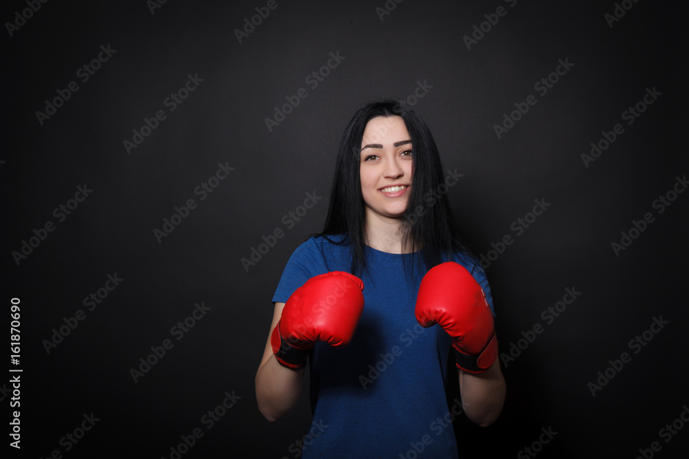 Sports young woman doing kick in boxing gloves Sports young woman doing kick in boxing gloves