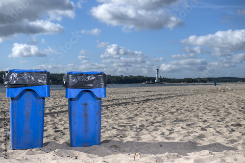 Blaue Mülltonnen am Strand