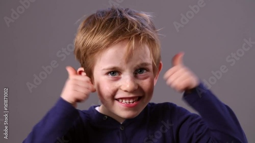 cheeky young preschool boy showing his excitement with thumbs up
