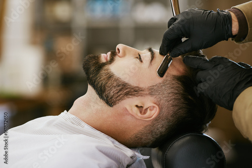 Dark haired man at barbershop © veles_studio