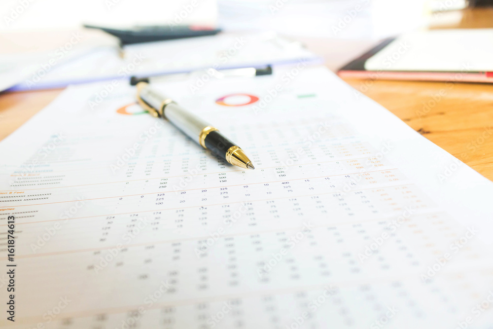 Business and financial reports with pen and calculator on wooden desk Business and financial reports with pen and calculator on wooden desk