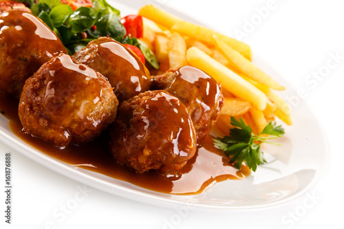 Roasted meatballs, chips and vegetables 