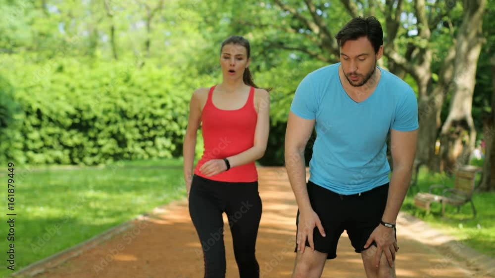 Exhausted man and woman catching breath after jogging, running at the park. Tired couple. close up Exhausted man and woman catching breath after jogging, running at the park. Tired couple. close up