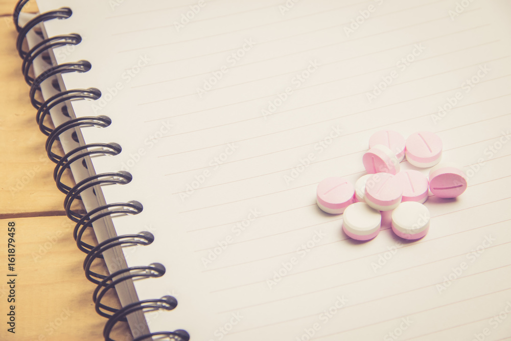 Group of Medicine on white blank book with copy space high angle view Group of Medicine on white blank book with copy space high angle view